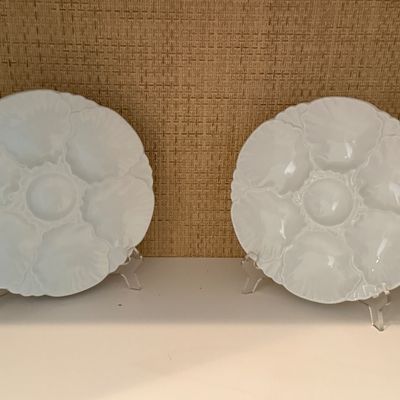Pair of vintage white glazed ceramic oyster plates featuring six shell-shaped wells 
