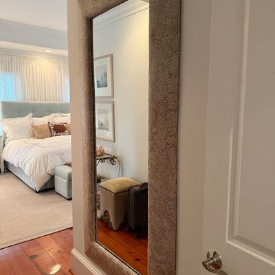 Large full-length wall mirror featuring a thick, crackled shagreen-style upholstered frame.