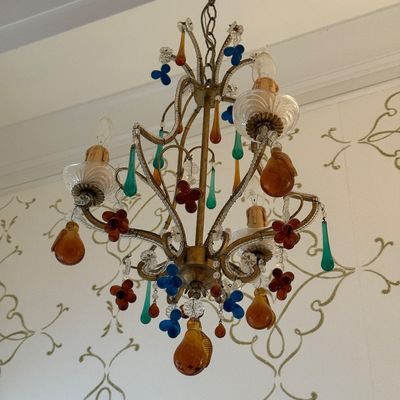 Sale Photo Thumbnail #106: Italian Venetian-style brass chandelier adorned with colorful glass fruits, flowers, and teardrop crystals.