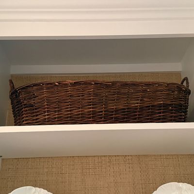 Large dark-stained woven twig or willow storage basket 