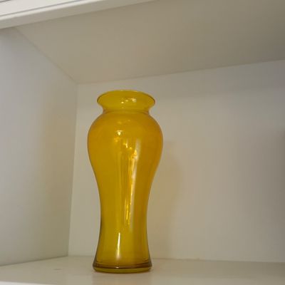 Sale Photo Thumbnail #101: Vibrant yellow amber glass vase displayed on a white shelf.