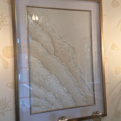 Framed contemporary 3D textured wave artwork in neutral tones, featuring a champagne gold metallic frame and double matting.