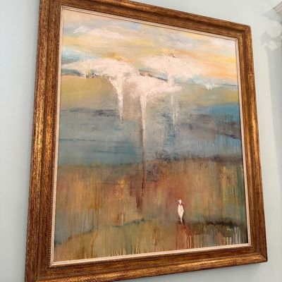 Large framed abstract landscape oil painting featuring angelic forms and a solitary figure, presented in an ornate gilt wood frame.