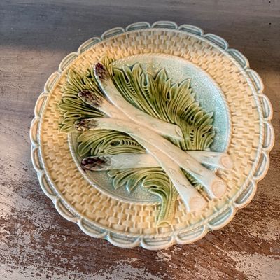 Vintage French majolica asparagus plate featuring relief-molded spears and leaves against a basketweave background.