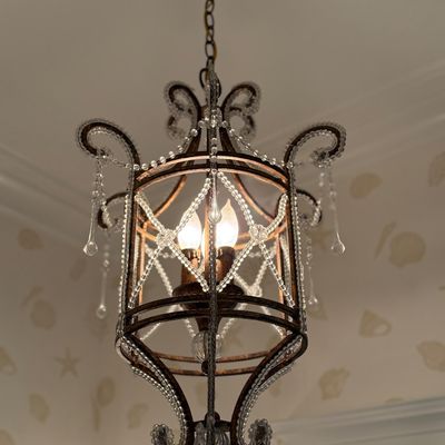 French-style wrought iron and beaded crystal pendant chandelier, featuring scrollwork arms and teardrop prism accents.
