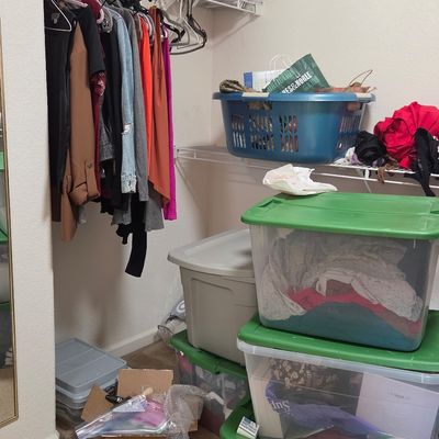 Sale Photo Thumbnail #65: Assorted clothing hanging on wire racks and stored in plastic bins, including a blue laundry basket and a Sephora cardboard box.