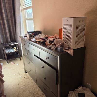 Sale Photo Thumbnail #69: Contemporary dark brown six-drawer dresser with silver-tone knobs, shown with various personal items and a white air purifier on top.