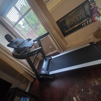 Sale Photo Thumbnail #4: Spirit Fitness motorized treadmill featuring a digital console, cup holders, and a folding design, shown in gently used condition.