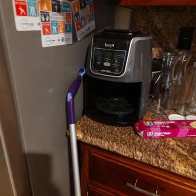 Sale Photo Thumbnail #20: Ninja XL air fryer in grey and black, shown sitting on a granite kitchen countertop.