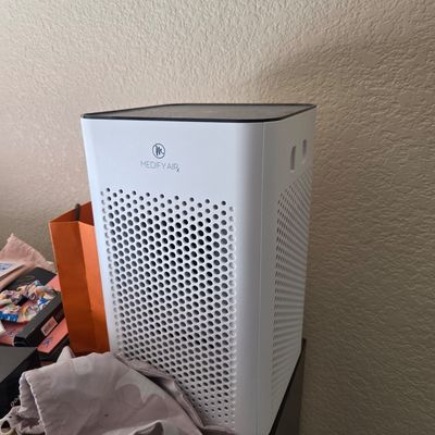 Sale Photo Thumbnail #70: Medify Air MA-40 air purifier in a white and black finish, featuring a sleek tower design with a perforated intake grille.