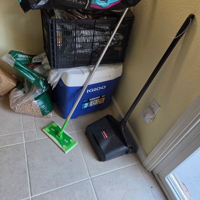 Sale Photo Thumbnail #78: Assorted household utility items including a Swiffer Sweeper, a Rubbermaid lobby dustpan, a blue Igloo cooler, and a black plastic crate.