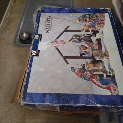 Sale Photo Thumbnail #35: Kirkland Signature 12-piece porcelain nativity set with wood creche, in its original box showing some shelf wear.