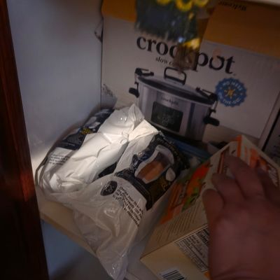Sale Photo Thumbnail #24: Crockpot slow cooker in its original box, stored on a shelf alongside replacement water filters and other household items.
