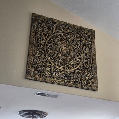 Sale Photo Thumbnail #36: Large, four-panel carved wood wall art featuring an intricate floral mandala design with gold-toned highlights.