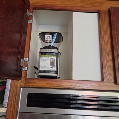 Sale Photo Thumbnail #72: Cuisinart Supreme Grind Automatic Burr Mill coffee grinder, stored inside a wooden kitchen cabinet.