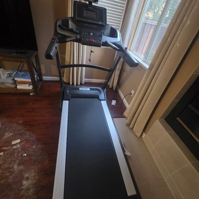 Sale Photo Thumbnail #5: Spirit Fitness folding treadmill featuring a digital console, cup holders, and a tablet holder, in gently used condition.