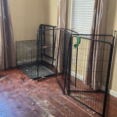 Sale Photo Thumbnail #38: Black wire dog crate with a plastic tray bottom, shown alongside a matching folding wire pet playpen.