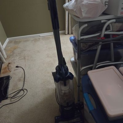 Sale Photo Thumbnail #33: Shark Navigator upright vacuum cleaner, showing some signs of use, positioned next to storage bins.