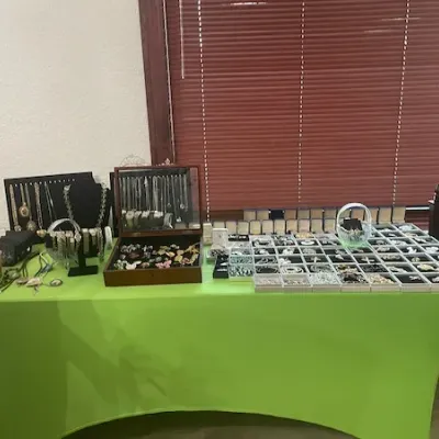 Large assortment of vintage jewelry, including necklaces, earrings, and brooches, arranged on displays and in trays.