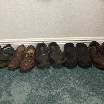 Collection of men's casual footwear, including leather loafers, slip-on shoes, lace-up Oxfords, and buckled sandals.