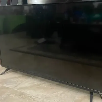 Vizio flat-screen smart television with black thin bezel frame and dual pedestal feet.