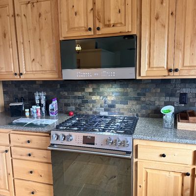 Sale Photo Thumbnail #3: Café stainless steel gas range and matching over-the-range microwave.