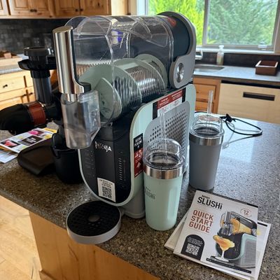 Sale Photo Thumbnail #13: Ninja Slushi professional frozen drink maker, complete with two insulated tumblers and the original quick start guide.