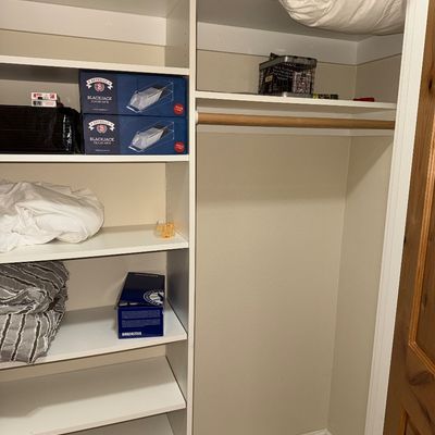Sale Photo Thumbnail #41: White laminate closet organizer system featuring built-in shelving and a wooden hanging rod.