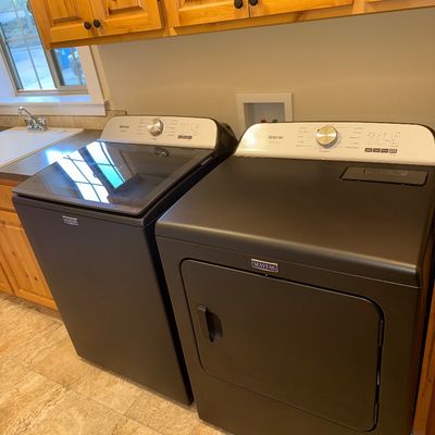 Sale Photo Thumbnail #8: Modern Maytag top-load washing machine and matching front-load dryer in a matte black finish with silver control panels.