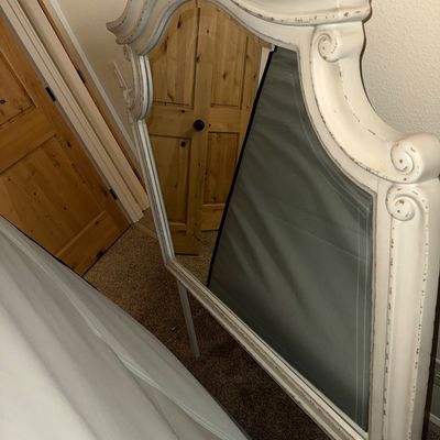 Sale Photo Thumbnail #31: French provincial style dresser mirror featuring a distressed white painted frame with scroll details and an arched top.