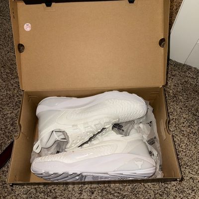 Sale Photo Thumbnail #25: Under Armour Project Rock athletic sneakers in all-white, presented in their original cardboard box.