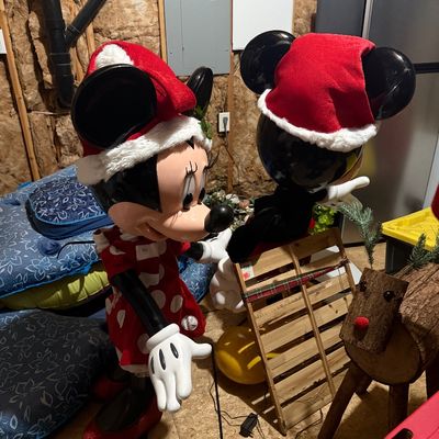 Sale Photo Thumbnail #51: Vintage Disney Minnie and Mickey Mouse Christmas blow mold figures, featuring Santa hats and festive attire, shown alongside a rustic wooden reindeer and sled.