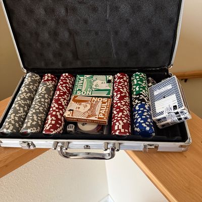 Sale Photo Thumbnail #15: Poker set in an aluminum carrying case, featuring Paulson playing cards, a dealer button, dice, and stacks of multi-colored clay poker chips.