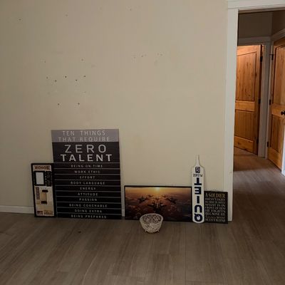 Sale Photo Thumbnail #37: Collection of wall decor and signs, including a large "Ten Things That Require Zero Talent" motivational sign, a fighter jet print, and a novelty "Quiet Please" paddle.