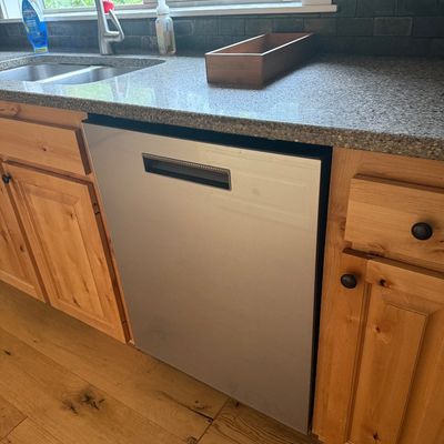 Sale Photo Thumbnail #4: Café Modern built-in stainless steel dishwasher with a recessed handle.
