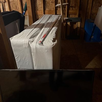 Sale Photo Thumbnail #18: Toshiba flat-screen television shown in the foreground of a storage area with wrapped beds.