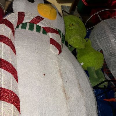 Sale Photo Thumbnail #46: Large 5ft outdoor Christmas decorations, including a lighted tinsel penguin holding a candy cane and a plush Grinch figure.