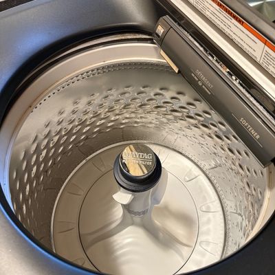 Sale Photo Thumbnail #7: Interior view of a modern Maytag top-load washing machine, featuring a stainless steel drum and a Pet Pro Filter agitator.