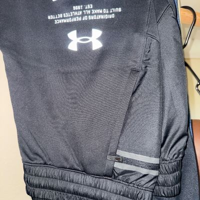 Sale Photo Thumbnail #27: Under Armour black athletic pants featuring an elastic waistband, zippered pocket, and white logo graphic.