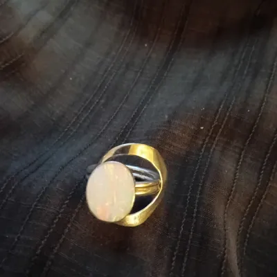 Modernist sterling silver and gold-tone ring featuring a large oval cabochon stone with an architectural frame.