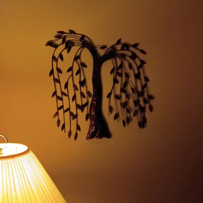 Sale Photo Thumbnail #59: Metal weeping willow tree wall sculpture mounted above a table lamp.