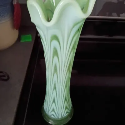 Sale Photo Thumbnail #5: Mid-century green and white slag glass vase featuring a ruffled rim and stylized feather pattern.