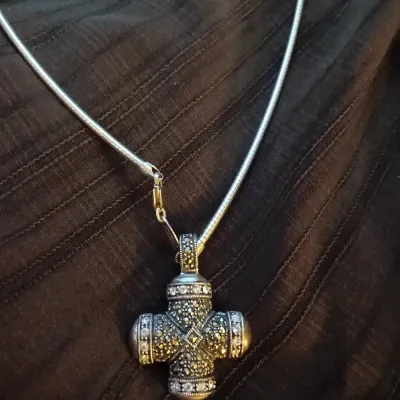 Sterling silver and marcasite cross pendant set with clear accent stones on a fine snake chain necklace.