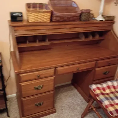 Sale Photo Thumbnail #20: Traditional wooden roll-top desk featuring multiple storage drawers, mail cubbies, and a selection of woven baskets displayed on top.