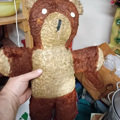 Sale Photo Thumbnail #25: Vintage handmade plush teddy bear featuring two-tone brown fur and simple white eyes.