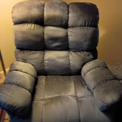 Sale Photo Thumbnail #56: Plush grey microfiber power recliner with tufted back and arm cushions.