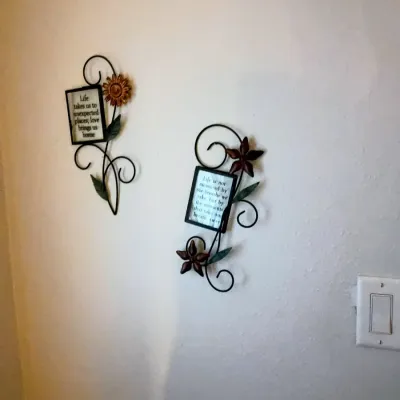 Sale Photo Thumbnail #38: Pair of wrought iron floral wall plaques with inspirational quotes and scrollwork details.