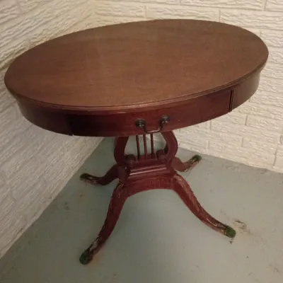 Sale Photo Thumbnail #17: Duncan Phyfe style mahogany oval side table featuring a harp lyre pedestal base with brass-capped claw feet.