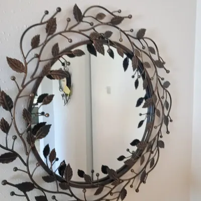 Sale Photo Thumbnail #6: Round wall mirror framed in decorative bronzed metal wirework featuring a botanical leaf and vine motif.