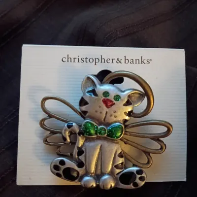 Christopher & Banks angel cat brooch featuring silver-tone and brass-tone metal accents with green glittery bow tie and eyes, mounted...